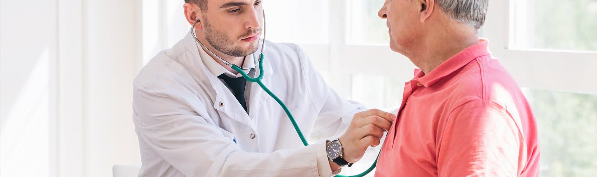 doctor examining patient's heart beat