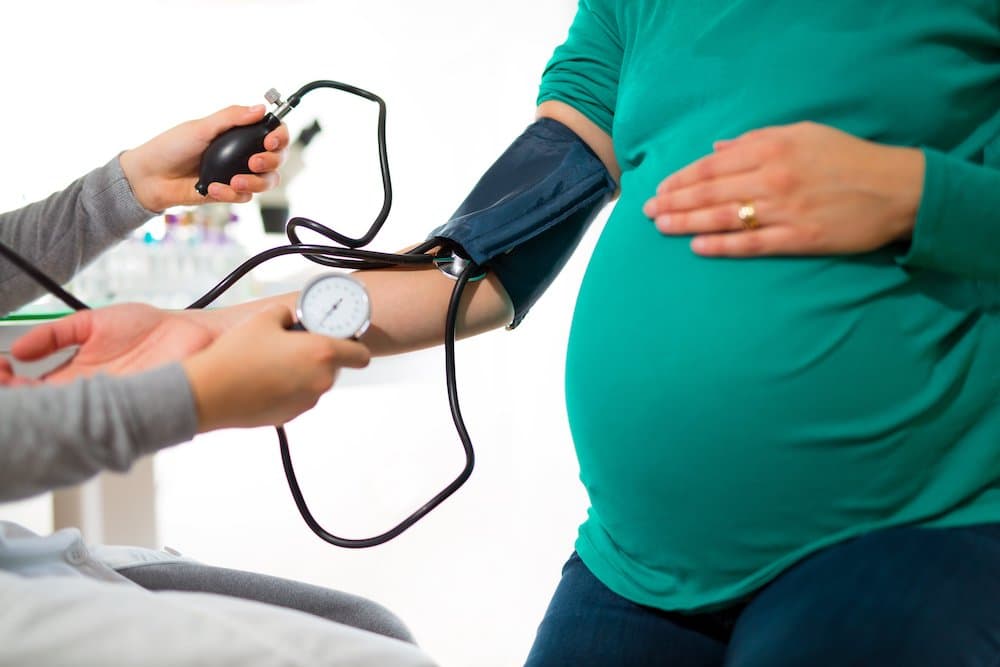 Image of Pregnant woman at doctor's office having pressure measured