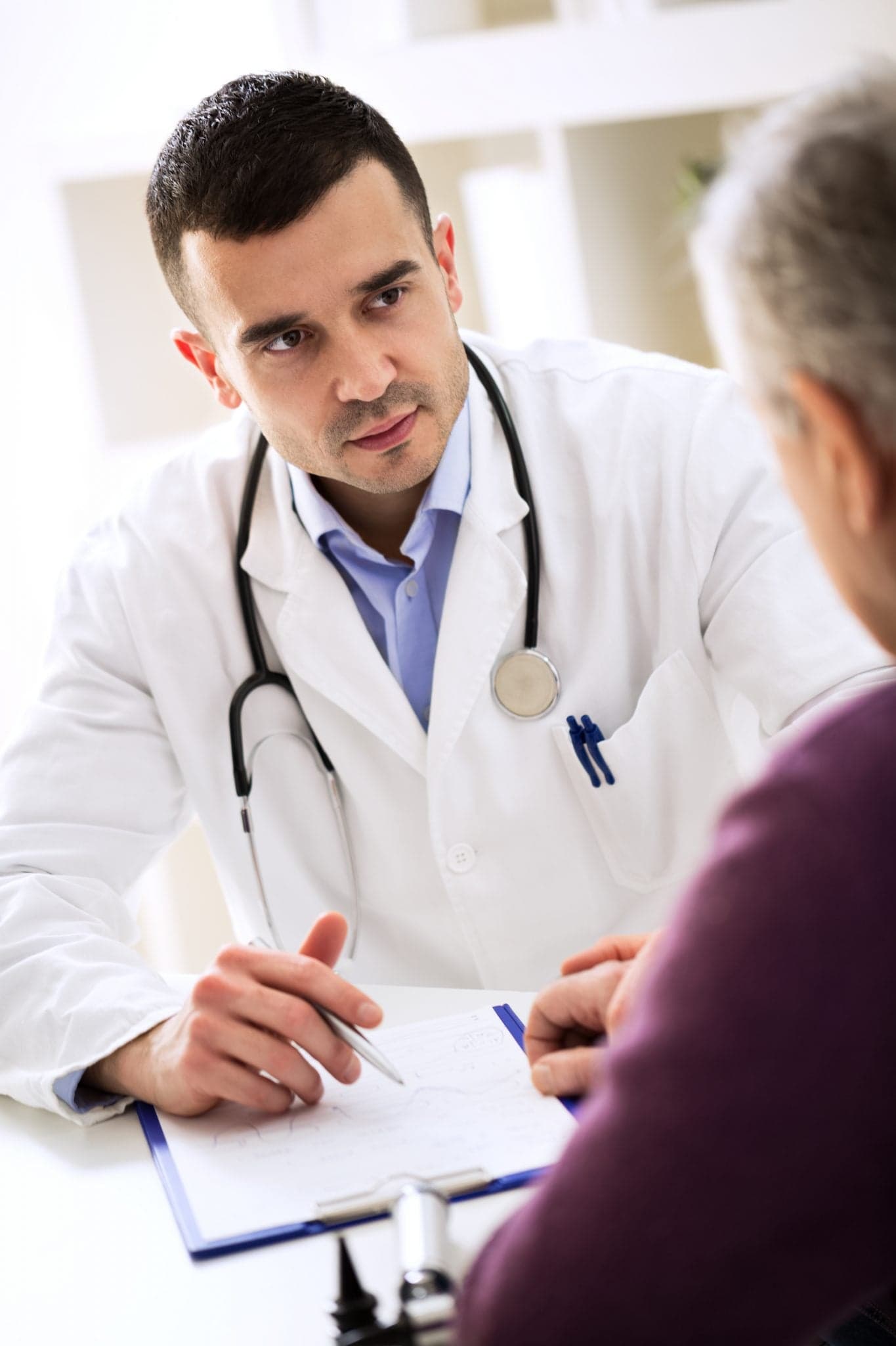 Image of Doctor listening to patient explaining his painful