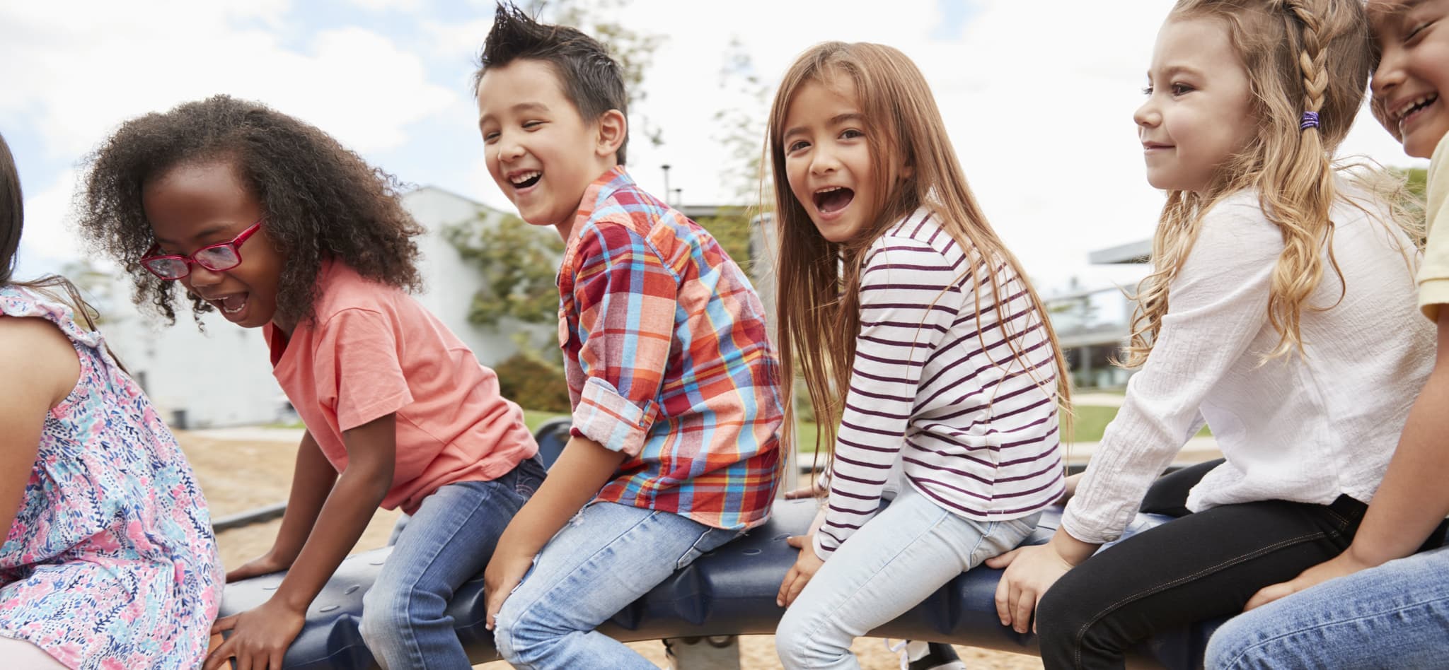 Picture of Kids playing on a spinning carousel in their schoolyard