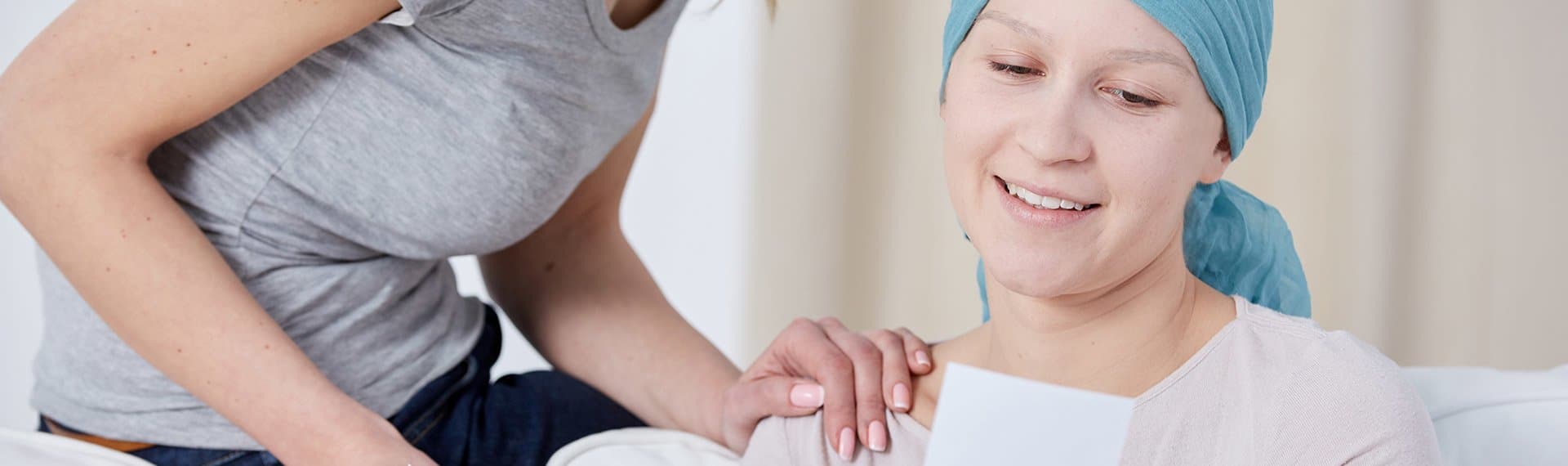 woman and female cancer patient talking