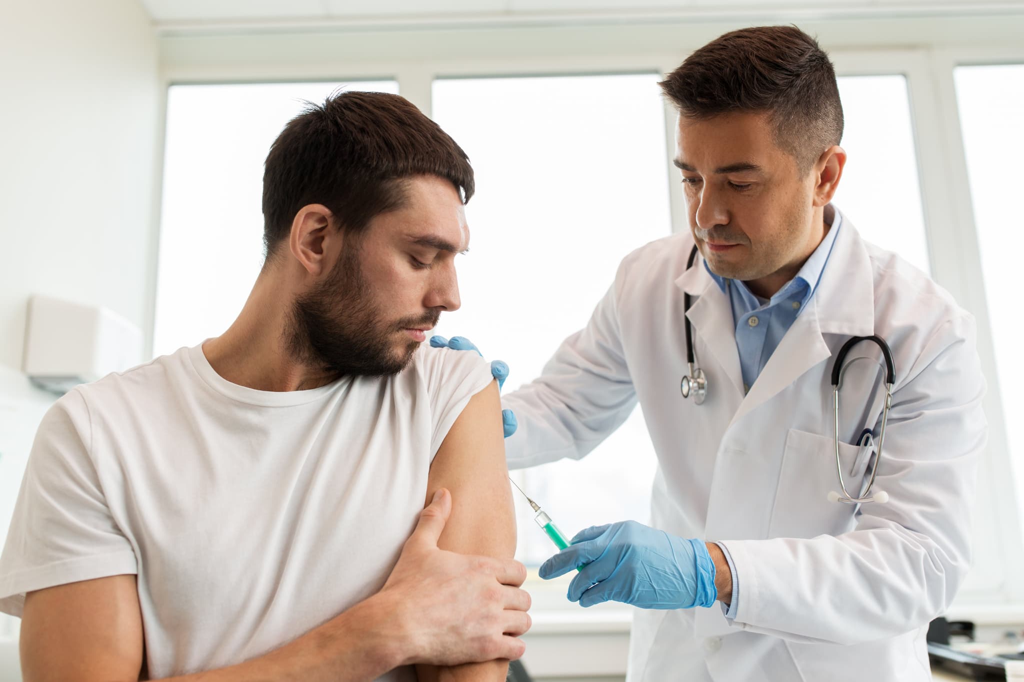 Picture of patient and doctor with syringe doing vaccination
